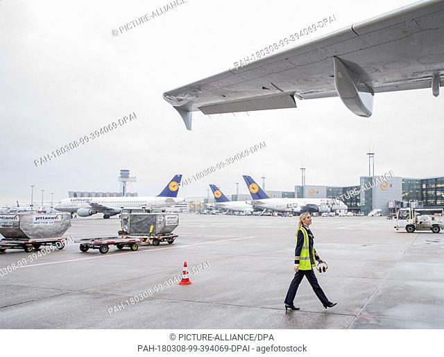 08 March 2018, Germany, Frankfurt: Laura Grammes, co-pilot, checking the airoworthiness of the Lufthansa Airbus A 321 before its flight to Berlin