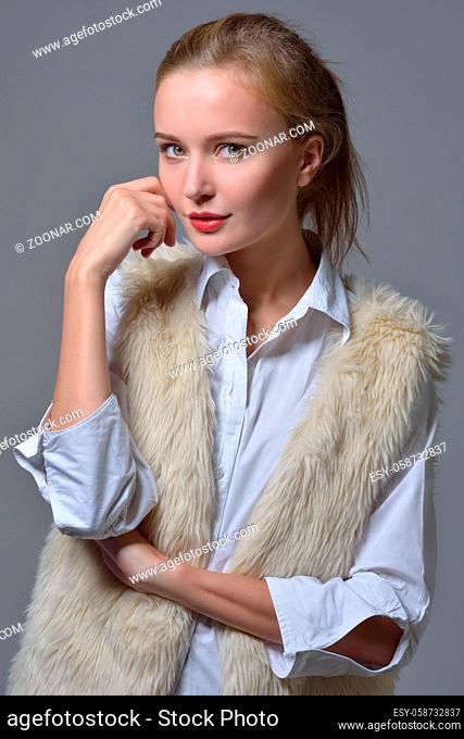 Torso portrait of the beautiful blonde woman in fur jacket