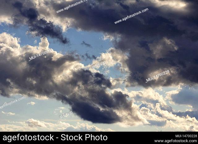 Dramatic rain clouds with blue sky in the background