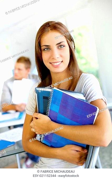 Portrait of smiling student girl in class