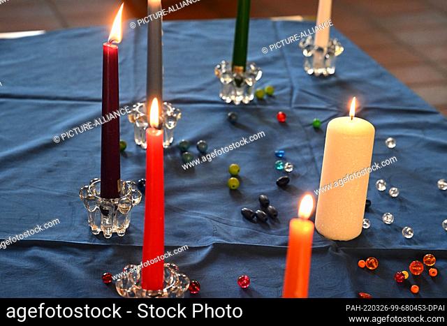 26 March 2022, Bavaria, MŸnchen: Candles burn before the start of the Protestant ""In spite of everything"" service for women who have been victims of sexual...
