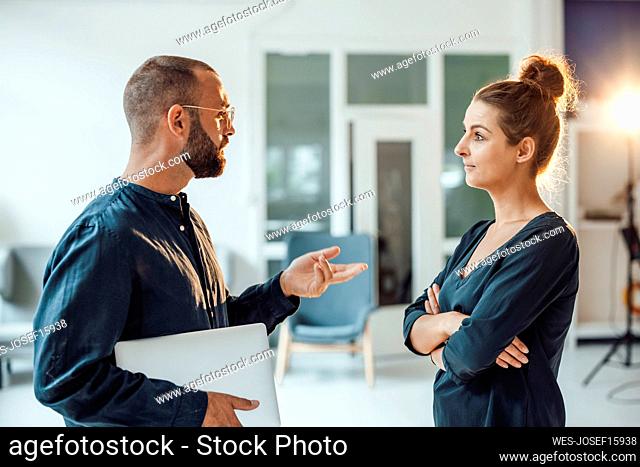Businessman discussing with colleague at home office