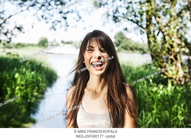 Germany, Cologne, Young woman smiling
