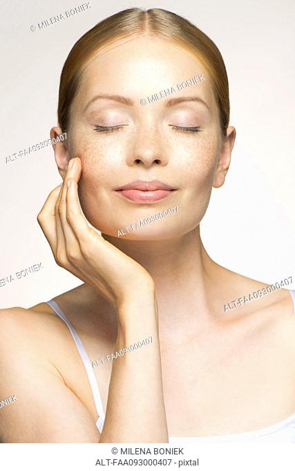 Young woman enjoying soft and smooth results of proper skin care