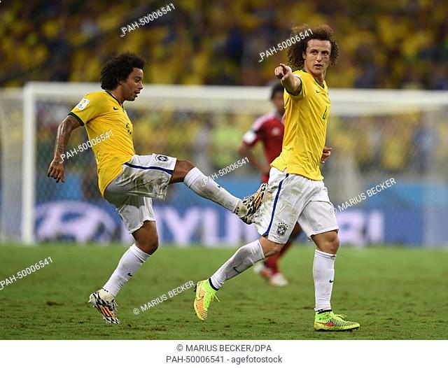 David Luiz of Brazil celebrates with teammate Marcelo (L) after scoring the 2-0 goal during the FIFA World Cup 2014 quarter final match soccer between Brazil...