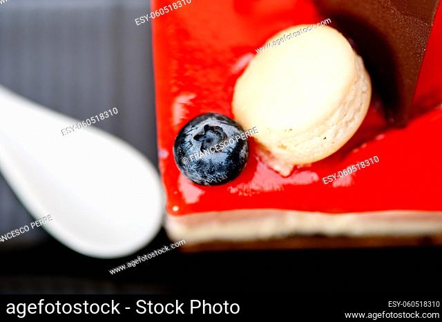 fresh strawberry yogurt mousse with macaroon and blueberry on top