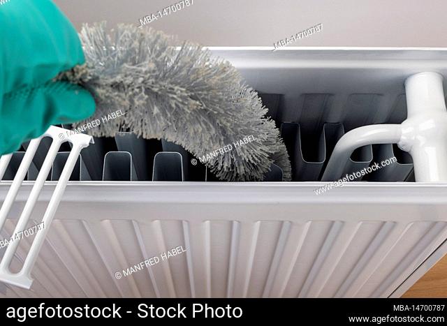 Clean radiator with radiator brush inside, white background, symbol image, clean regularly, improves heating performance
