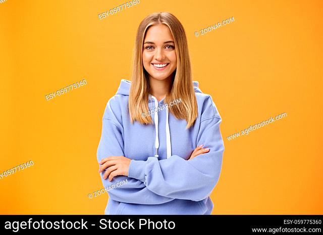 Young creative and ambitious female student staring own project at home working freelance having free time and working when want holding hand crossed on chest...
