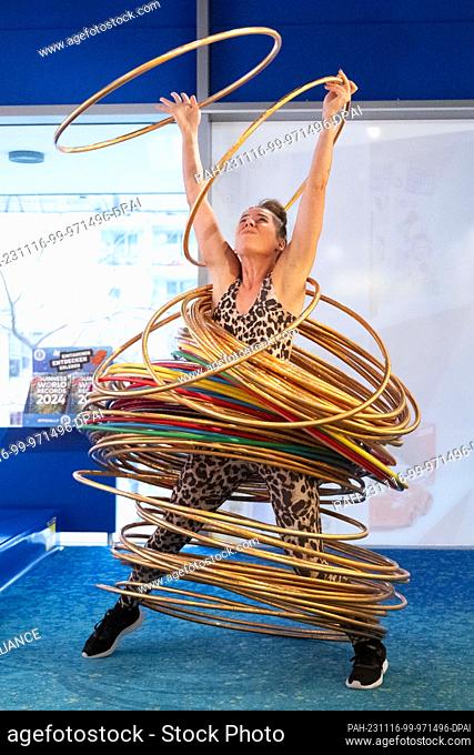 16 November 2023, Saxony, Dresden: Dunja Kuhn moves 84 hula hoops with her body in a world record attempt. Kuhn thus surpasses her previous record from 2021 by...