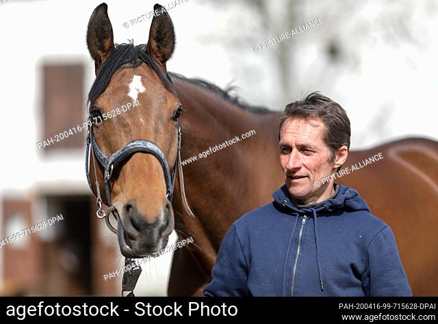 15 April 2020, Saxony, Leipzig: Leipzig's head trainer Marco Angermann holds the horse Mockingjay. The six-year-old gelding ended the 2019 season unbeaten with...