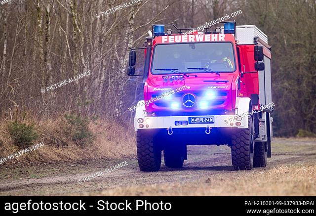 01 March 2021, Lower Saxony, Celle: A new forest fire tanker Unimog U5023 drives through the heath near the Lower Saxony State Office for Fire and Disaster...
