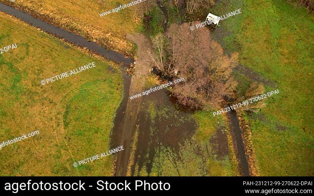 12 December 2023, Saxony-Anhalt, Tanne: Flooded meadows in the Upper Harz near Tanne (photo taken with a drone). The Warme Bode has exceeded the reporting limit...