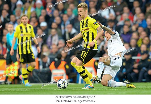 Dortmund's Marco Reus (C) and Real's Angel di Maria (R) vie for the ball during the UEFA Champions League semi final second leg soccer match between Borussia...