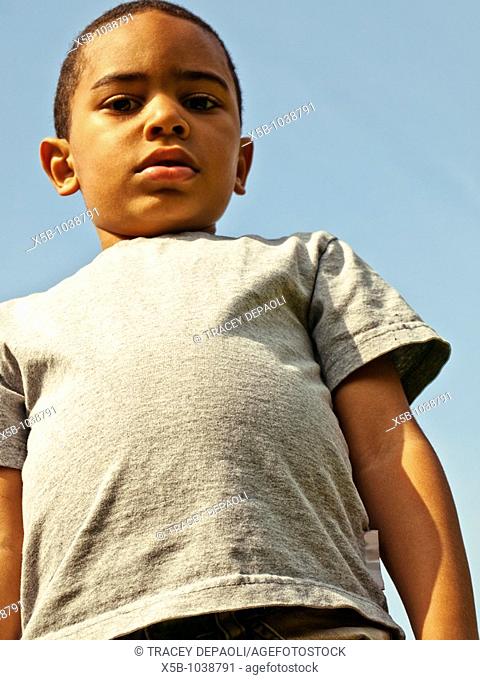 5 year old boy standing looking into camera  above camera  multiracial, vertical