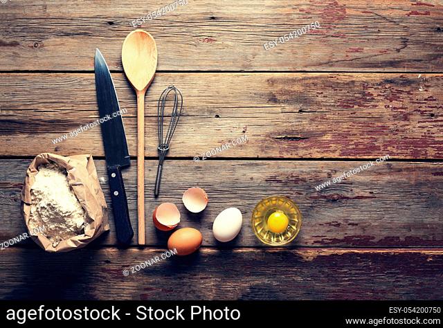 Bakery background. Home cooking. Kitchen accessories, flour and eggs. View from above. wooden background. top veiw