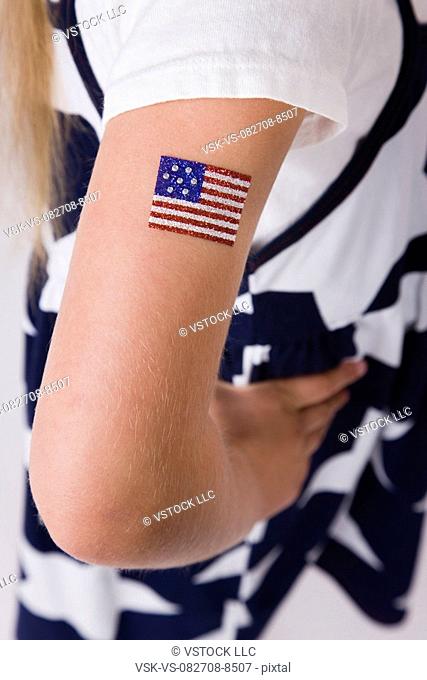 Close-up of girl's 8-9 arm with American flag painted