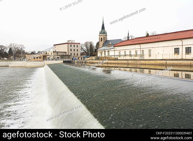 Hydroelectric power plant, weir and fish passage on Jizera river and St. Jacob's the Older Church in Prepere, Turnov, Liberec Region, Czech Republic, March 19
