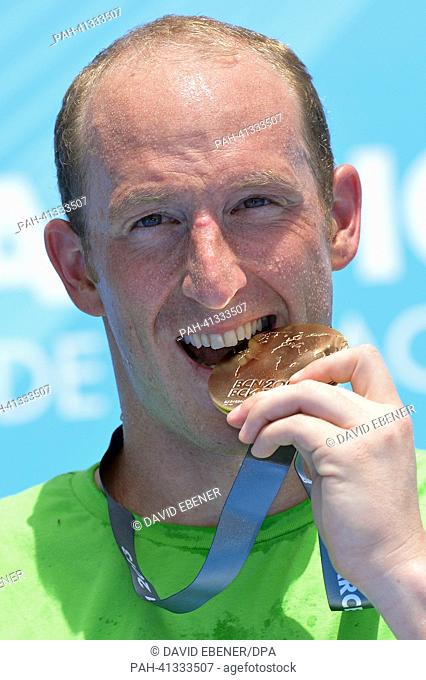 Gold medalist Thomas Lurz of Germany celebrates on the podium after the men's 25 km Marathon Open Water event of the 15th FINA Swimming World Championships at...