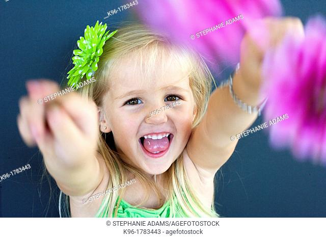 young girl showing flowers to camera