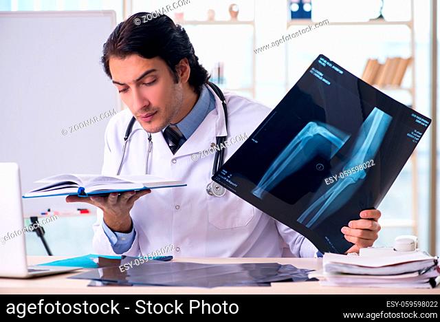 Young handsome male radiologist in front of whiteboard