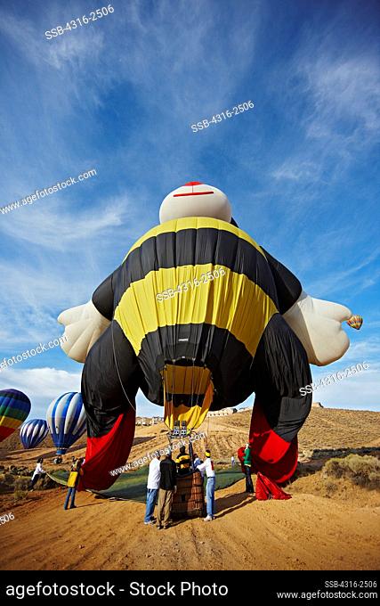 A bee shaped balloon deflating after a successful flight at the Reno Balloon Races, Reno, Nevada