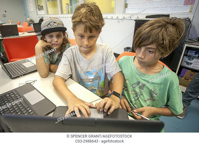Caucasian boys work at laptops in a Boys and Girls Club computer lab in Laguna Beach, CA