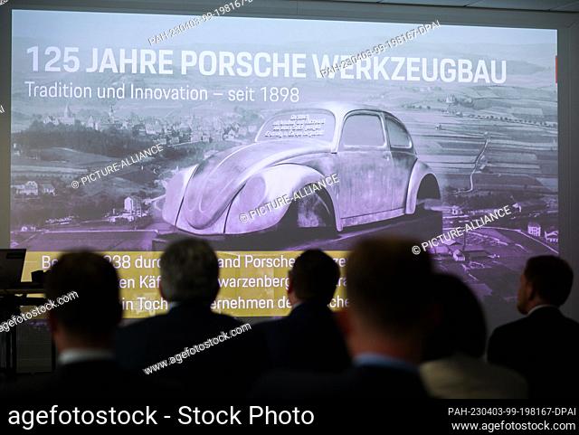 03 April 2023, Saxony, Schwarzenberg: Guests view a presentation of Porsche Werkzeugbau GmbH with the body of a VW Beetle