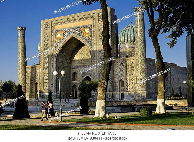 Uzbekistan, Silk Road, Samarkand, listed as World Heritage by UNESCO, Registan place, walking people in front of the Sher-dor Madrasah
