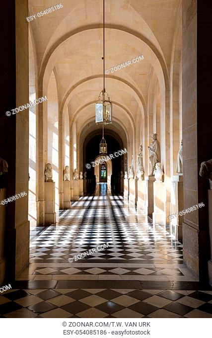 Marble hallway with bright sunlight at the Palace of Versailles near Paris, France