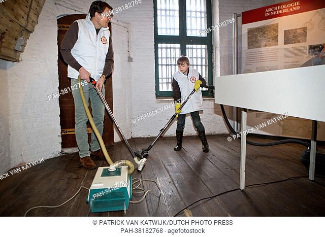 Prince Constantijn (L) of The Netherlands with his son Count Claus-Casimir of The Netherlands volunteering volunteering for NL Doet at Museum Gevangenpoort in...