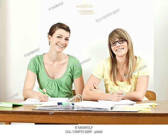 Two students sitting at table