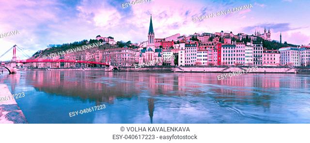 Panoramic view of Saint Georges church and footbridge across Saone river, Old town with Fourviere cathedral at gorgeous sunset in Lyon, France