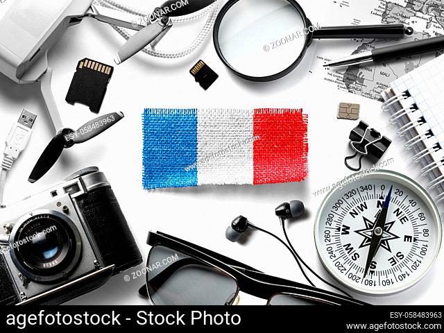 Flag of France and travel accessories on a white background. The view from the top