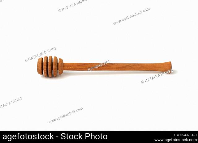 wooden stick for stirring honey isolated on a white background, close up