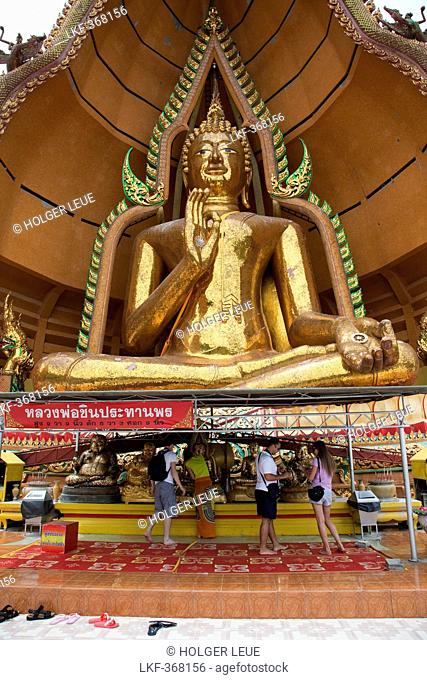 People in front of Giant Buddha, Wat Tham Khao Noi, Khao Noi Cave Temple, near Kanchanaburi, Thailand