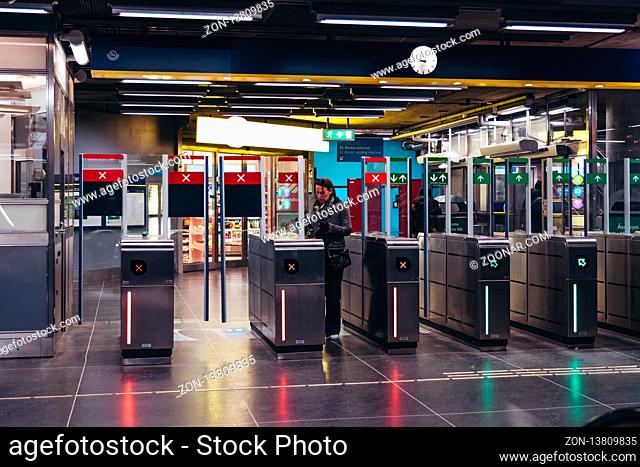 Editorial 03.27.2019 Stockholm Sweden. Woman showing her ticket to the machine and baffle gates at the subway station