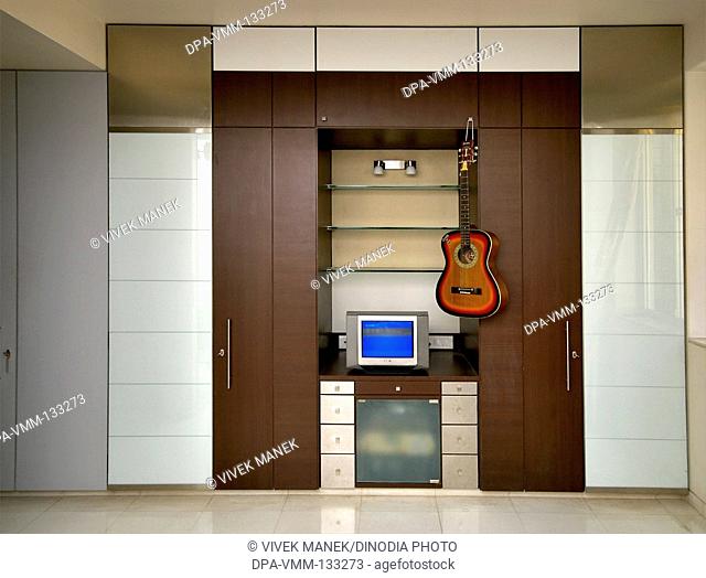 Interior of house ; television with guitar ; Mulund ; Bombay Mumbai ; Maharashtra ; India