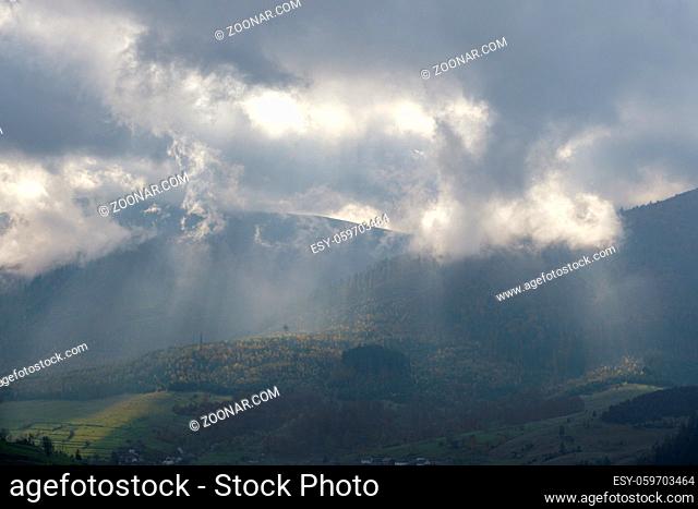 Morning foggy clouds in sunlight and autumn mountain countryside. Ukraine, Carpathian Mountains, Borzhava Range, Transcarpathia