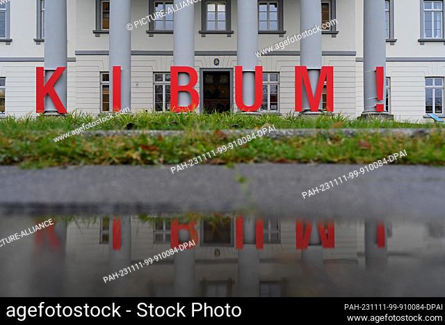 11 November 2023, Lower Saxony, Oldenburg: Large red letters with the inscription ""KIBUM"" (Children's and Young People's Book Fair) stand in front of the city...