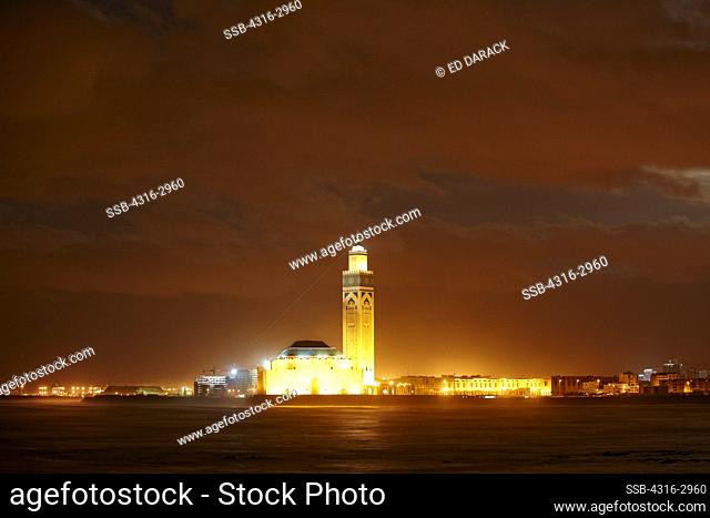 Nighttime view of the Hassan II Mosque. The minaret is the tallest in the world at 210 meters high. The laser on the upper minaret emits a green beam which...
