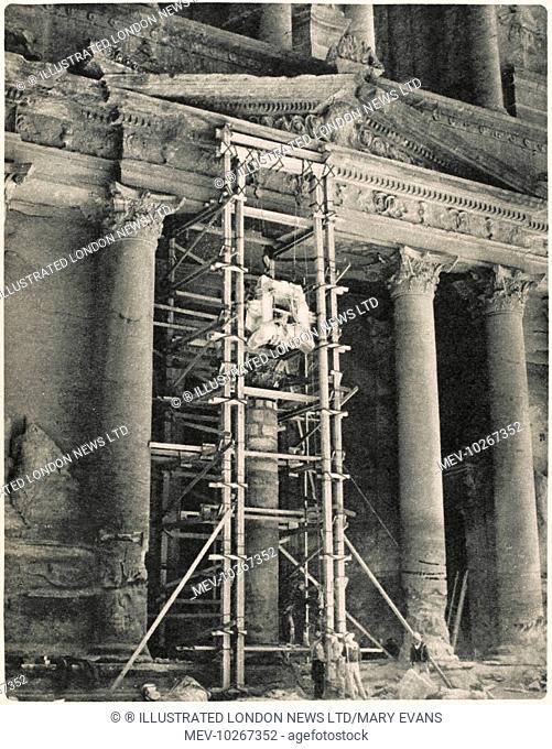 Restorations in the desert: repair work among the monuments of Petra, Jordan. This picture shows the closing stages of repair to fallen column which is part of...