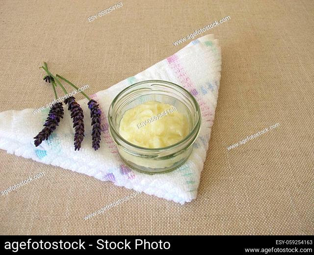 Homemade deodorant with essential lavender oil in a glass jar