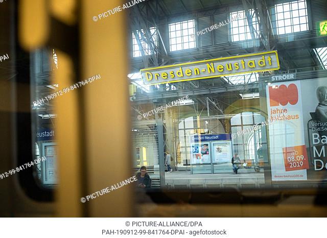 05 September 2019, Saxony, Dresden: Passers-by can be seen through the window of a train of the Czech railway company on a line from Berlin to Prague on the...