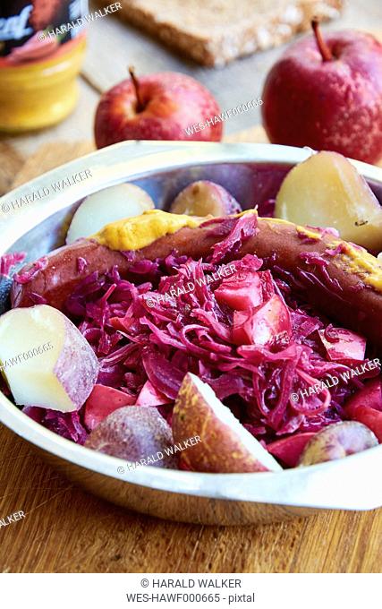 Red cabbage with apples, served with red skinned potatoes and a vegan sausage
