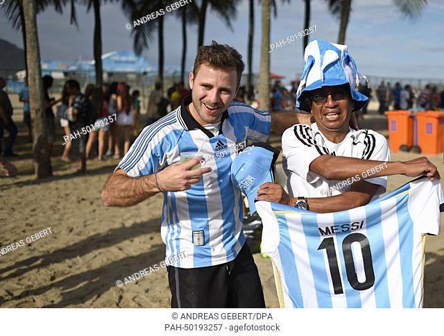 An Argentinian supporter (L) wearing a Messi shirt poses with a street hawker the FIFA Fan Fest on the Copacabana beach in Rio de Janeiro, Brazil, 12 July, 2014