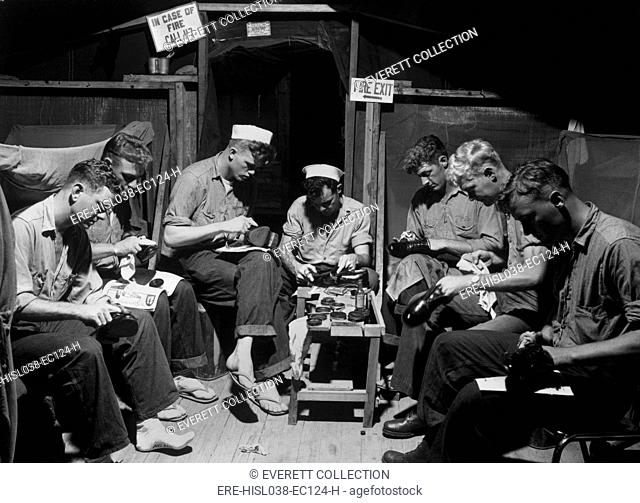 U.S. sailors shining shoes prior to acting as honor guard at Panmunjom armistice signing. July 23, 1953. Korean War, 1950-53. (BSLOC-2014-11-151)