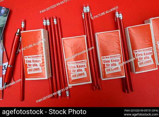 08 October 2020, Saxony, Chemnitz: Handkerchief packages with the inscription ""Eine Kasse für alle"" and red pencils lie on a table during an open-air meeting...
