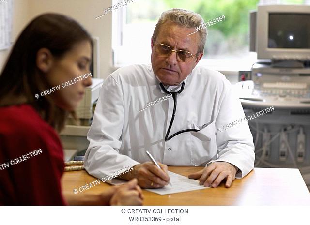 Doctor with notepad listening to patient