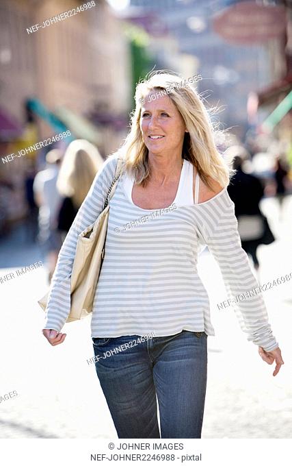Blond woman walking on street