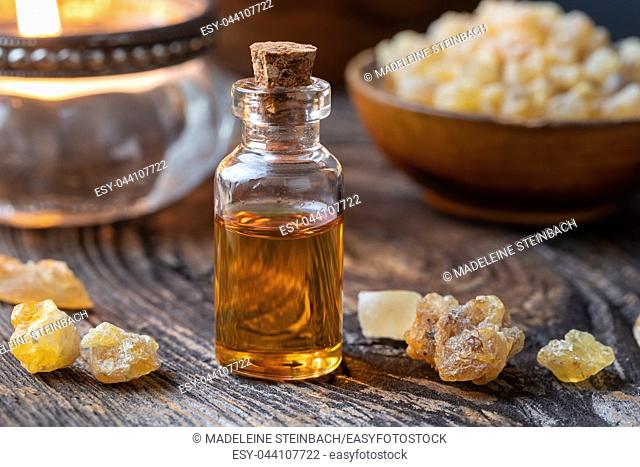 A bottle of essential oil with frankincense on a table